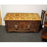 A 19th century oak coffer /ottoman heavily carved and with lion face drawer pulls.112cm(W) 54cm(H)