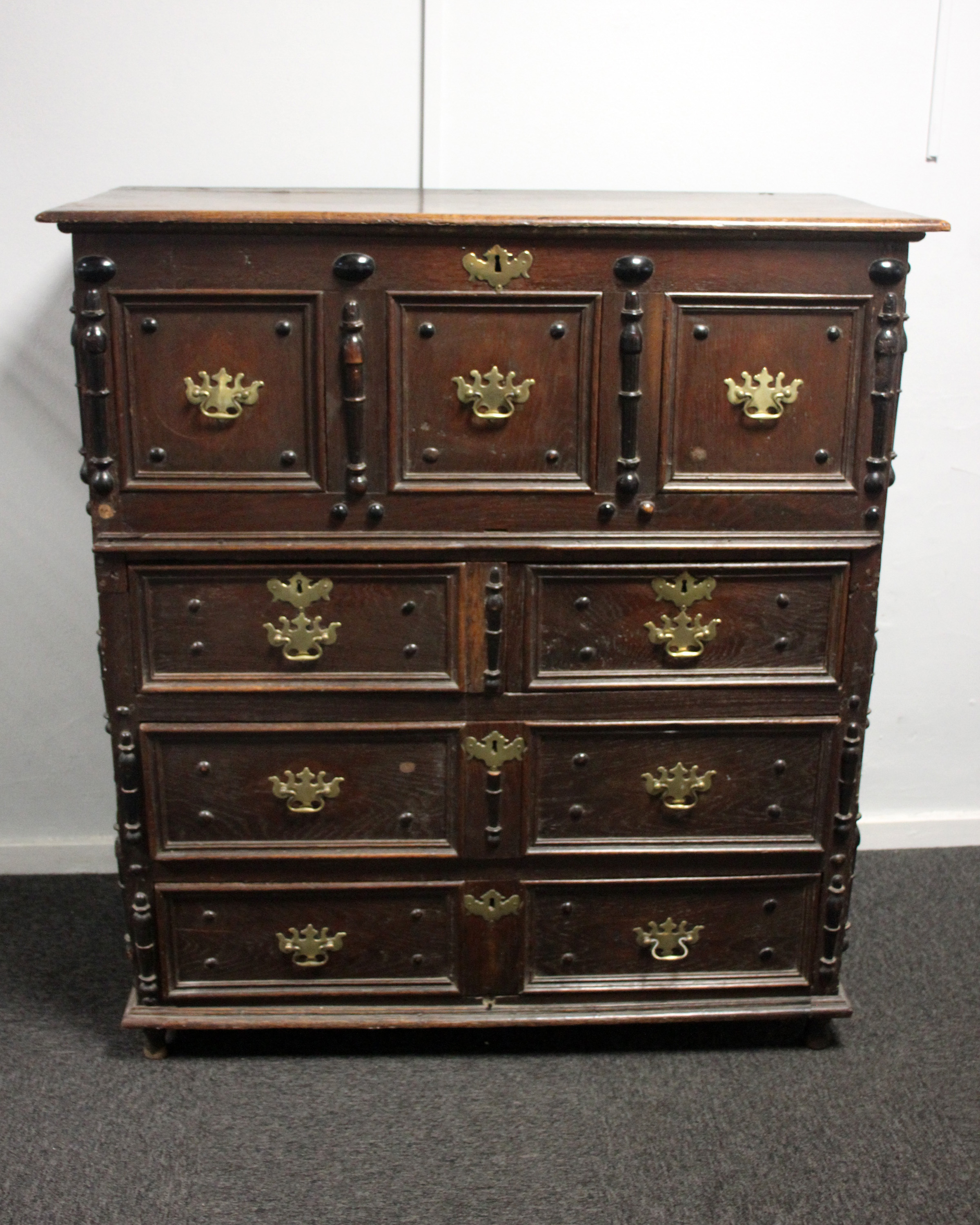 A late 17th century English joined oak coffer on chest. The top section with period paper lining