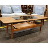 A G-Plan style 1970s two tier coffee table with glass insert top. 136cm x 50cm