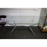 A 20th Century glass topped dining table on chrome legs, 180cm x 90cm