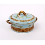 A George Jones majolica lidded pot moulded in relief with blossoming branches and woven wicker