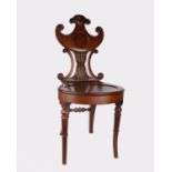 A Regency carved mahogany hall/porters chair with carved shield back circa 1740