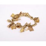 An 18ct gold charm bracelet set throughout with 9ct charms. 43.2g gross