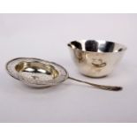 A sterling silver tea strainer with silver slops bowl. 158g