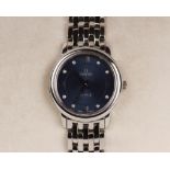 A Ladies Omega DeVille Quartz movement wristwatch in white metal with blue face and diamond baton