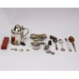 A collection of small silver and white metal items.