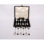 A boxed set of six sterling silver tea spoons together with a set of six sterling silver coffee