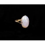 A 9ct gold and opal ring. Oval cabochon opal 20mm x 15mm. size L