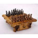 A small chess set with wooden board and storage drawers. 21cm x 21cm