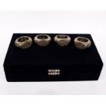 A cased set of eight Oman silver napkin rings based on traditional Bedouin jewellery items.