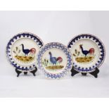 Two similar circa 1900, Llanelli pottery cockerel plates with blue sponge decorated borders together