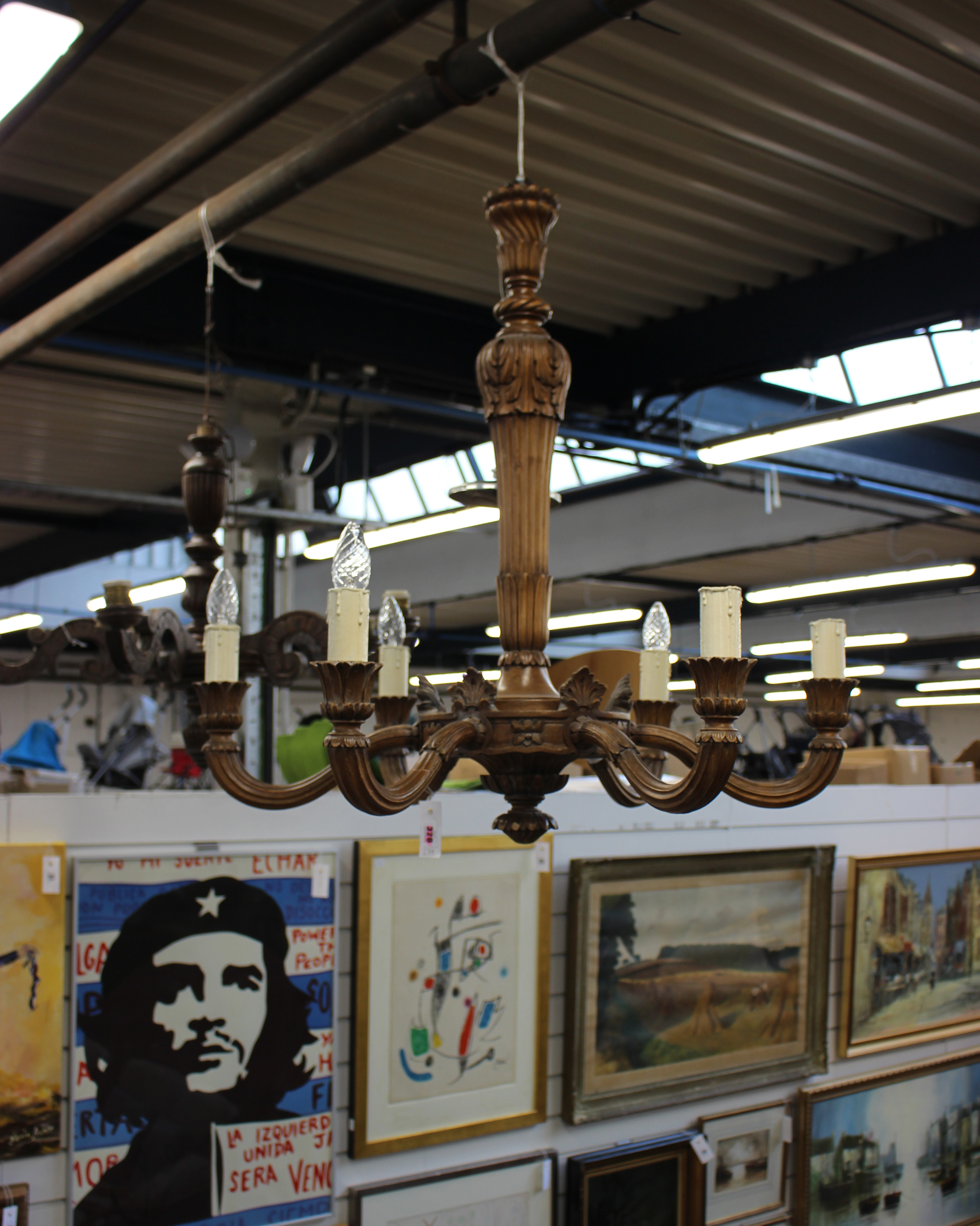 Two Edwardian carved oak six branch chandeliers in the arts and craft style larger one signed A.