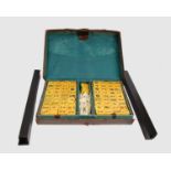 An early 20th century Chinese Mah-jong set in leather carry case with stands. (complete)