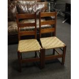 A pair of oak framed ladder back chairs with lattice woven rush seats (Possibly 'Letchworth by