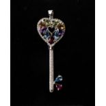 An 18k white gold, diamond and gem set key pendant. Set throughout with single cut diamonds and pear