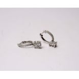 A pair of 18k white gold and diamond earrings. Single cut half set diamond hoops with bale suspended