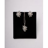 An 18k white gold and diamond flower pendant and earrings set throughout with single cut diamonds