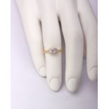 An 18ct gold and platinum single stone diamond ring. Bright cut panel with central illusion set