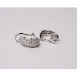 A pair of 18k white gold and diamond half hoop earrings each set with five lines of single cut