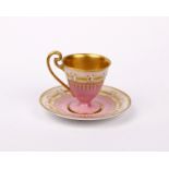 A Royal Worcester cabinet cup and saucer in fine pink and gilt decoration with dot mark for 1921.