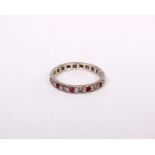 An 18ct white gold ruby and diamond full eternity ring. 3.8g. Size R.