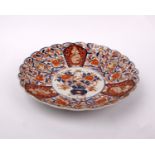A 19th century Japanese Imari pattern footed shallow bowl with scalloped edge.Diameter 30cm