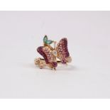 An 18k rose gold Emerald, Ruby and Diamond butterfly ring. Centrally set with single pear cut