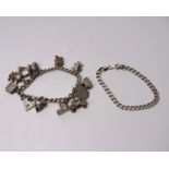 A sterling silver charm bracelet set with silver and white metal charms, together with a silver curb