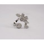 An 18k white gold and diamond flower spray ring set throughout with clusters of single cut