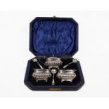 A boxed sterling silver set of two salts, mustard and spoons in blue velvet lined box.