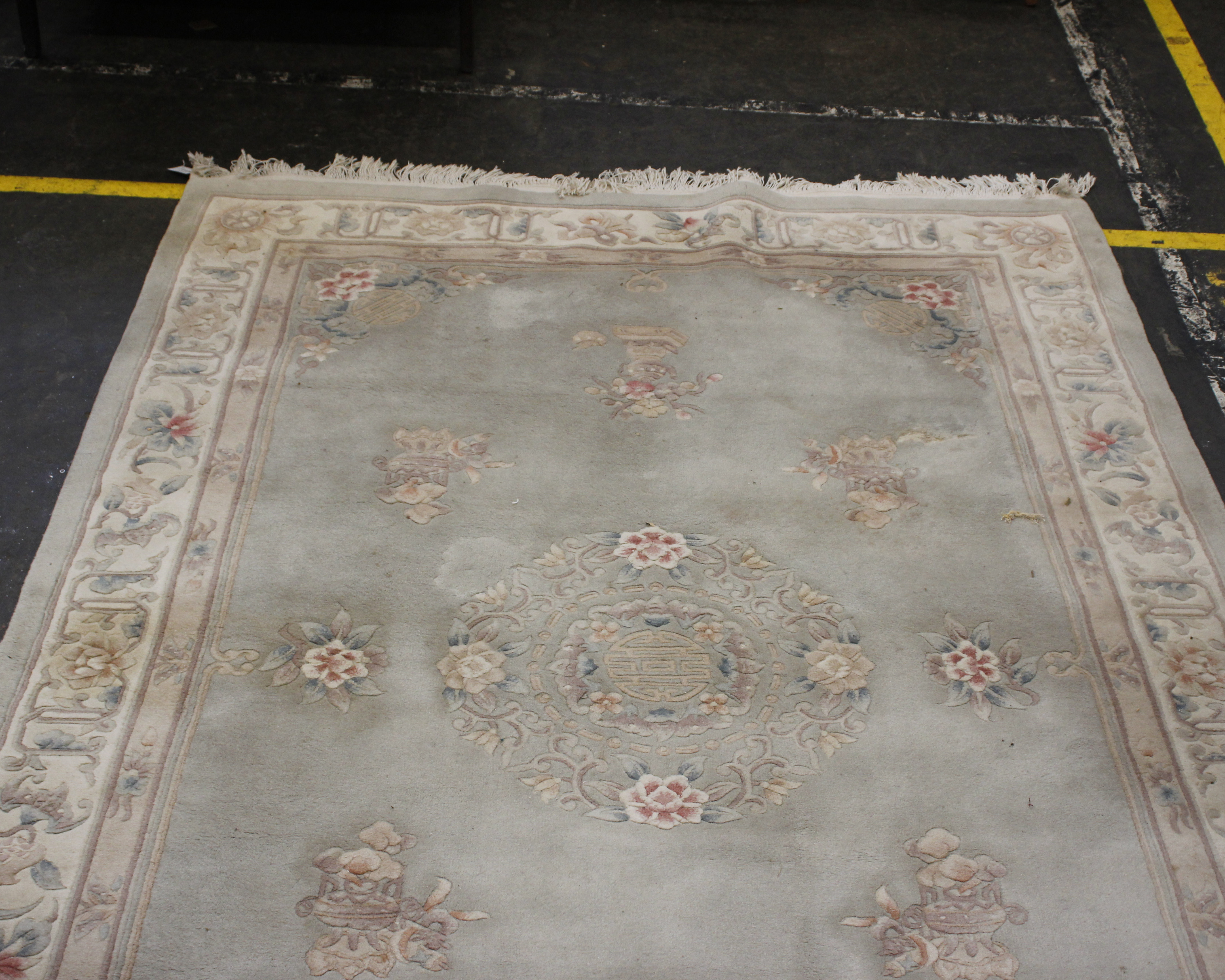 A large Chinese machine woven wool rug, pink floral patterned on pale blue ground.300cm x 182cm