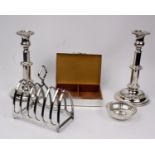 A pair of electroplated candlesticks together with a large plated toast rack and engine turned