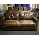 Two seater modern square arm leather sofa in chocolate, studs to front arms. Dimensions 81cm(L) x