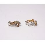 A pair of 18k white and rose gold diamond set earrings with three intertwined lines of single cut