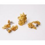 A collection of 24K gold jewellery to include a flower ring with two pairs of matching earrings.