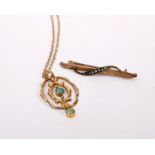 A 9ct gold open work pendant set with central cabochon turquoise on a yellow metal chain together