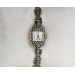 A Ladies Art Deco white metal and marcasite cocktail watch on integral marcasite strap.