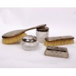 A sterling silver part dressing table set with three white metal topped glass items.