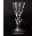A Georgian English lead wine glass, the flared bucket bowl on knopped hexagonal stem with folded