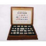 A boxed collection of commemorative sterling silver stamps. 25 stamps of royalty in presentation