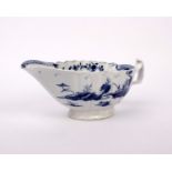 An 18th century lobed pearl ware sauce boat hand painted in under glaze blue with an oriental