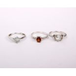 Three 9ct white metal gem set ladies rings. Size N. 6.6g.