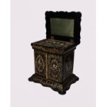 An early 19th Century black lacquer and papier mache sewing work box cabinet having abalone shell