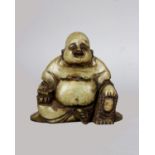 A carved green soapstone figure in the form of a seated Buddha