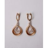 A pair of 18k rose gold and diamond chandelier earrings. Diamond set hoops with an openwork