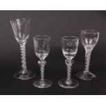 An 18th century air twist stem wine glass together with another smaller one and a pair of 18th