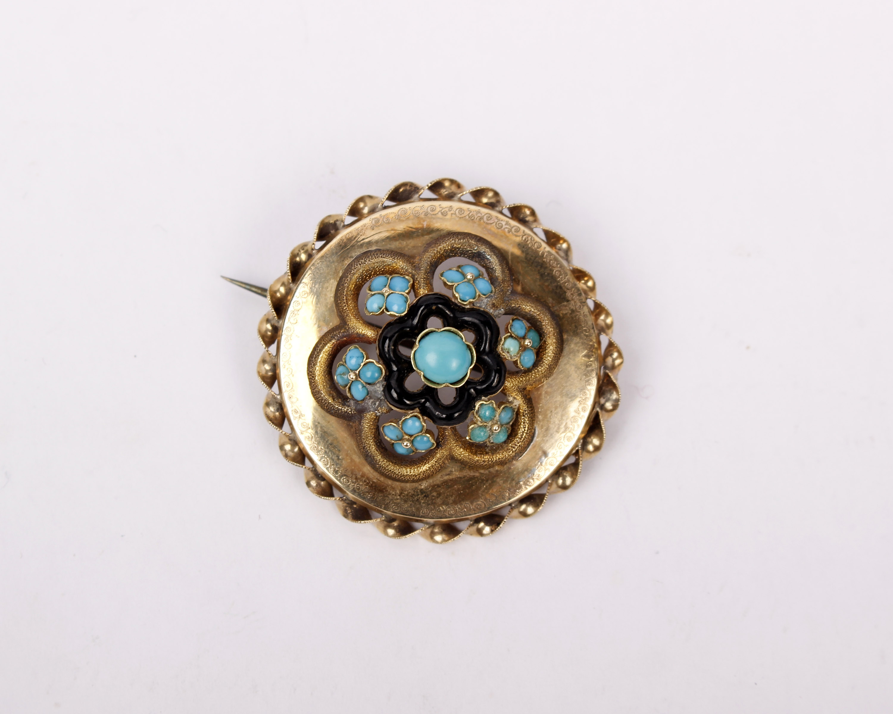 An unmarked yellow metal 19th century Etruscan style wheel brooch set with turquoise cabochons and