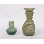 A small roman glass flask or 'Unguentarium' with applied glass trail to neck and body, together with