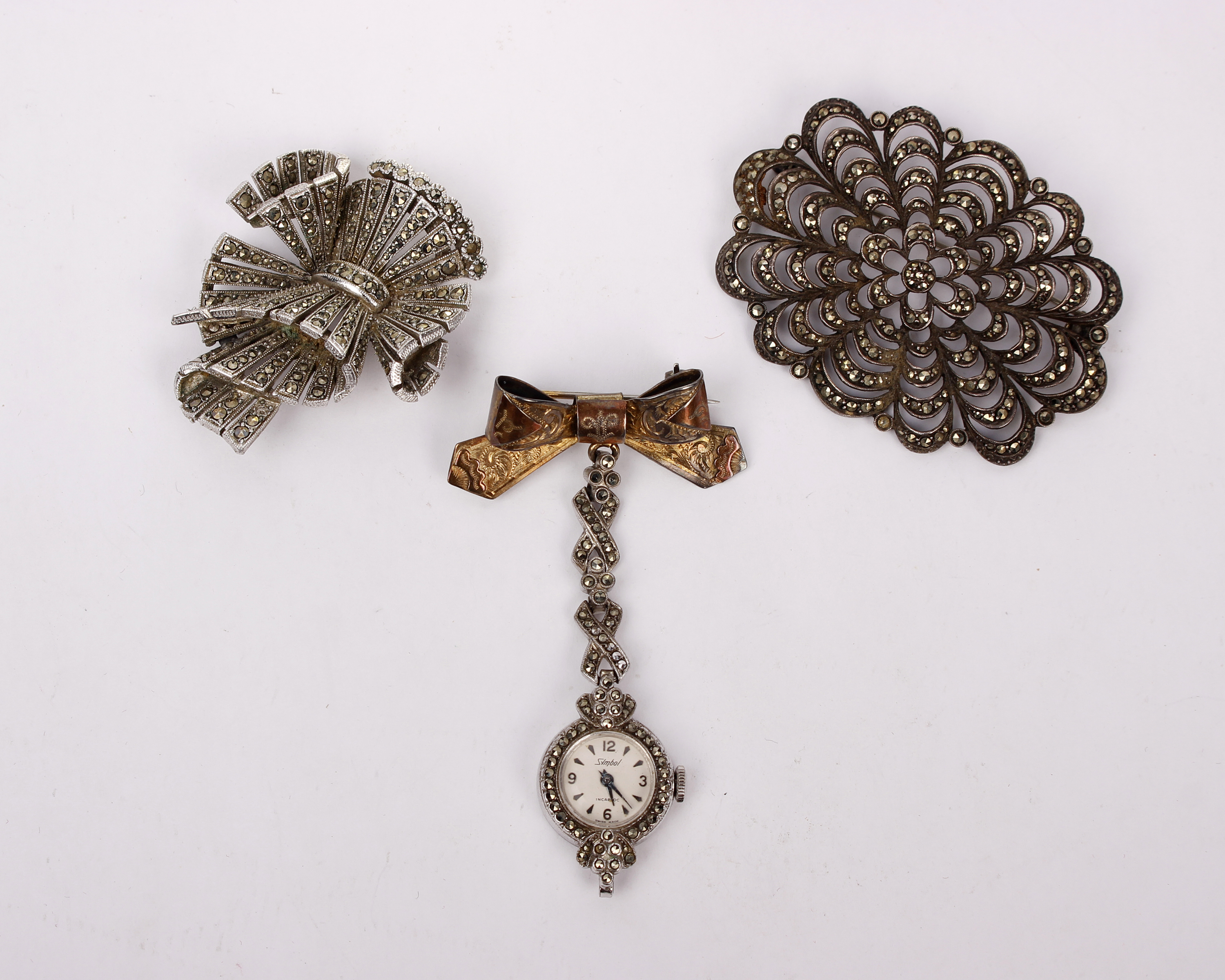 A marcasite lapel watch together with two pieces of Victorian marcasite jewellery.