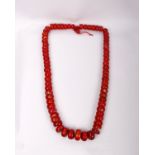 An important large red coral bead necklace 18th/19th Century. Largest bead 35mm x 15mm.